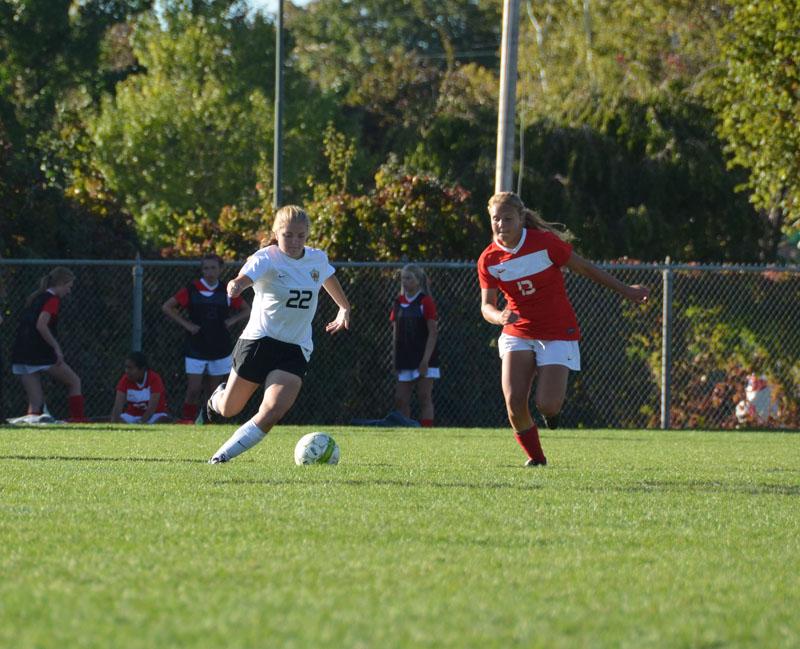 Emma Thornton attacks with the ball against an East defender. 