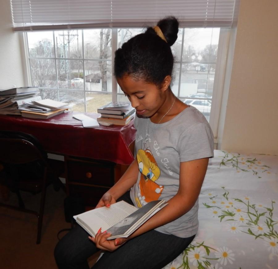 Rahula Gebresilase sits in her room reading one of her favorite books.