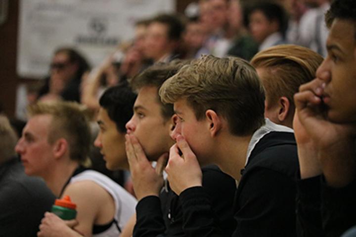 The Highland bench watches as the game against East intensifies.