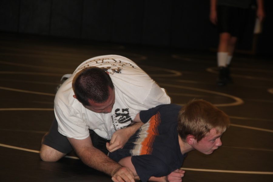 Coach Sierer wrestles against his son Collin during a team practice.