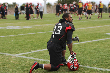 Gionni Paul takes a knee while playing for the Utes.