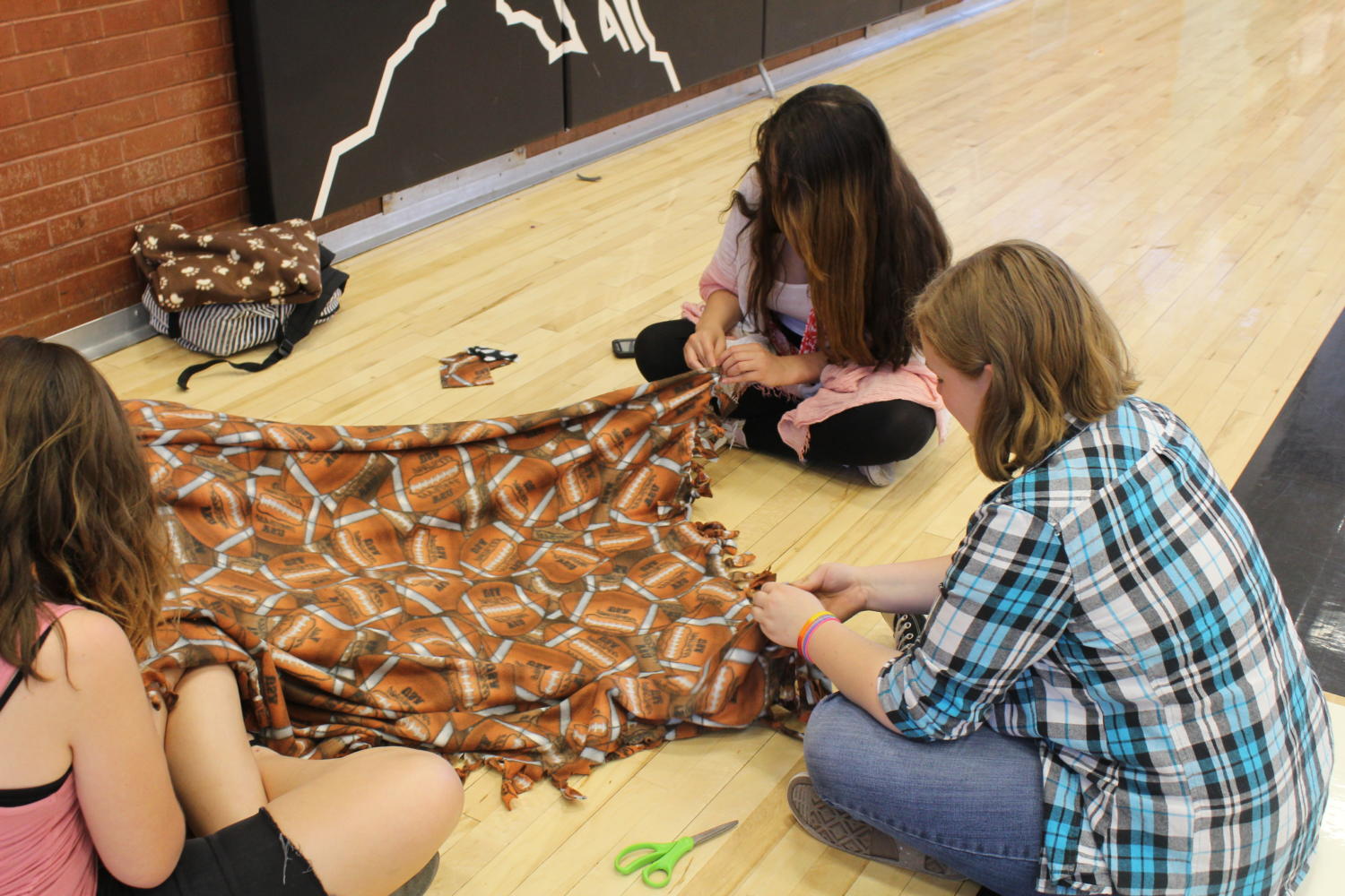 Students tie blankets for charity.