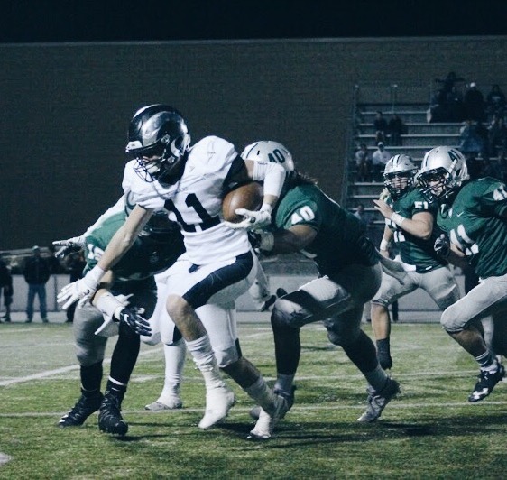 Junior Matthew Lloyd runs past Olympus players in an attempt to score a touchdown.