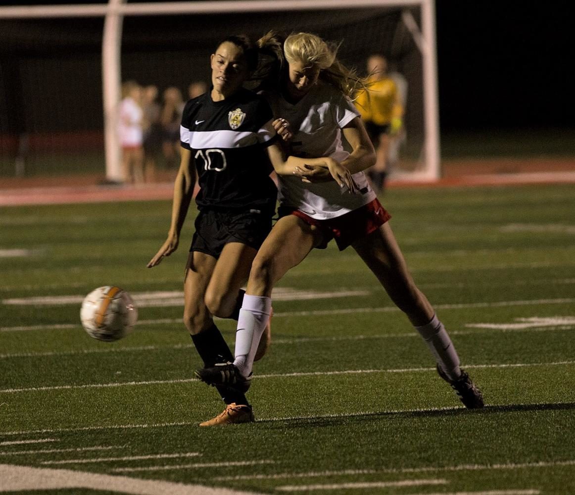Sydney Pujol fights off an East defender and tries to push towards the goal.