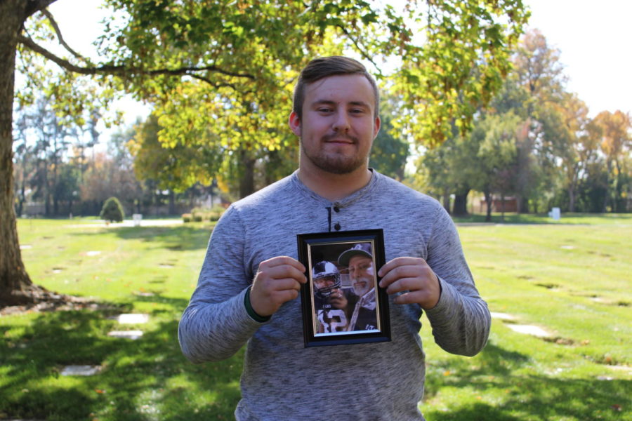 Bryan Geertgens holds a photo of him and his father.
