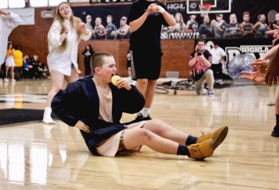 Keaton Campbell performs in front of the senior class with an Eggo in hand.