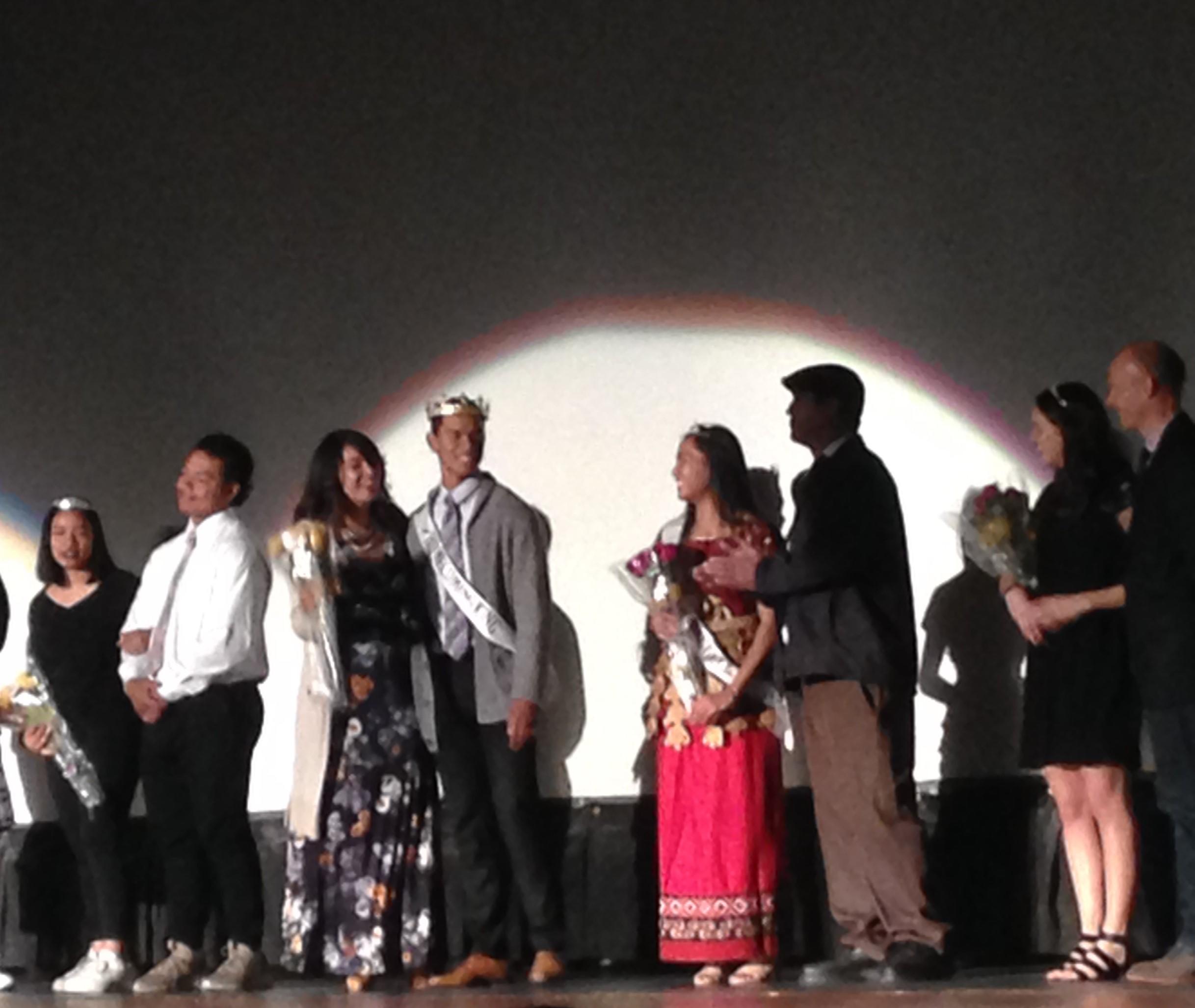 Bronson Olevao (fourth from the left) poses for pictures with his mom and all the other royalty during Thursday's Homecoming assembly.
