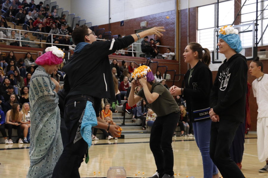Students participate in  an activity during the Club Rush assembly.