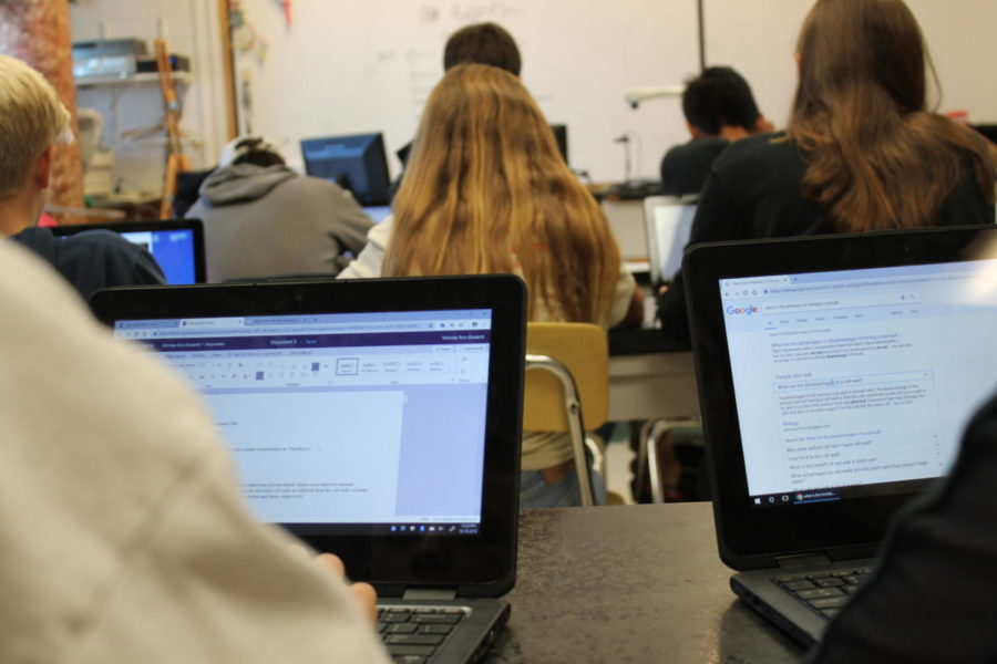 Students taking notes on school laptops during class