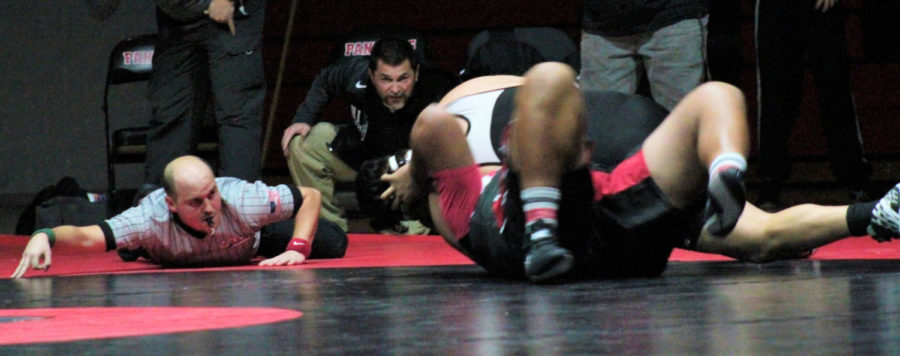 Highland wrestling coach Ted Sierer watches intently during a match vs. West High.