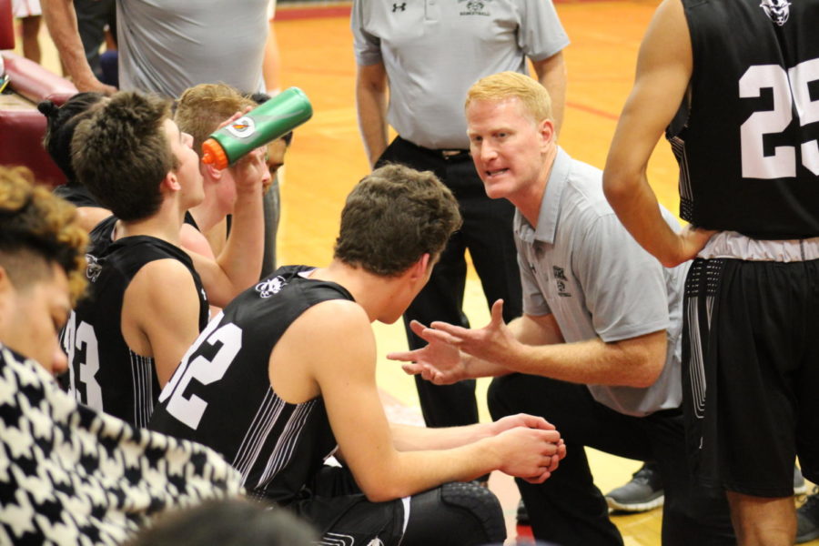 Head coach of the Rams, Jim Boyce, gives the players a pep talk during a timeout.