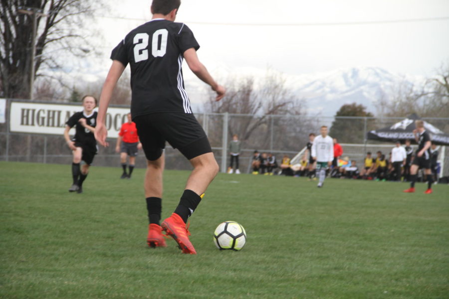 Highlands Owen Ross dribbles the ball up the field during the game against Olympus.