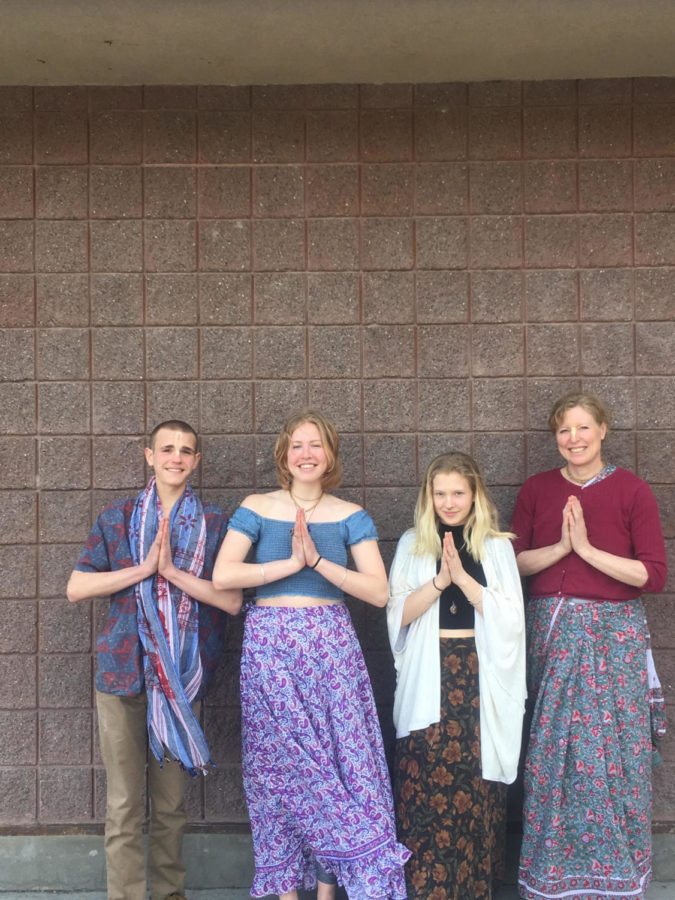 Shyamamohini Diana, pictured second, her mother, far right, and the two co-heads of the Bhakti Yoga club stand in front of the school in prayer pose. 