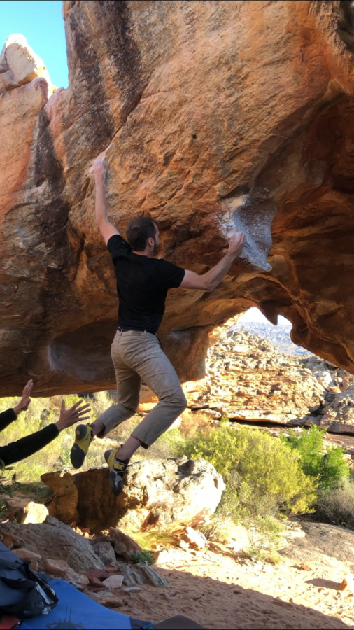 Creed Archibald hangs from a boulder problem in the Cederberg Mountain in South Africa.