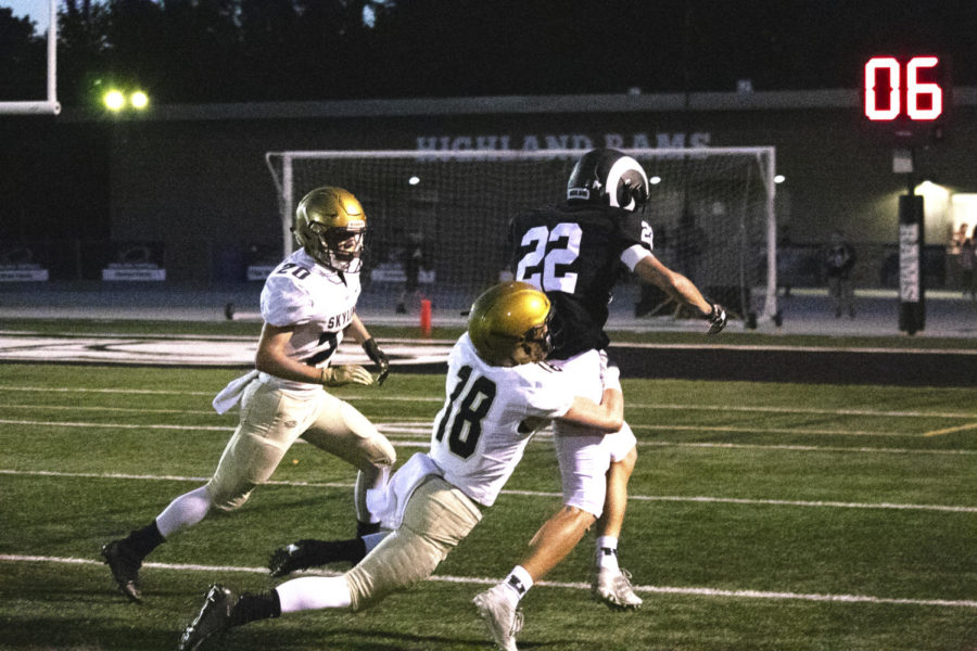 Zach+Levy+running+the+ball+against+Skyline.