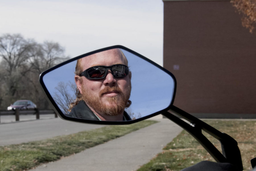 Steve Manwaring in the mirror of his motorcycle.