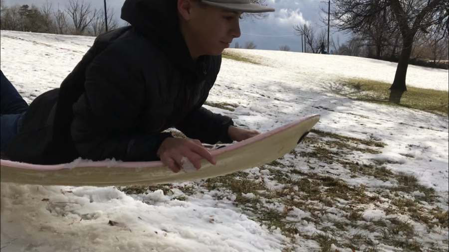 Sam Smart flies off a jump he made while sledding at Sugar House Park.