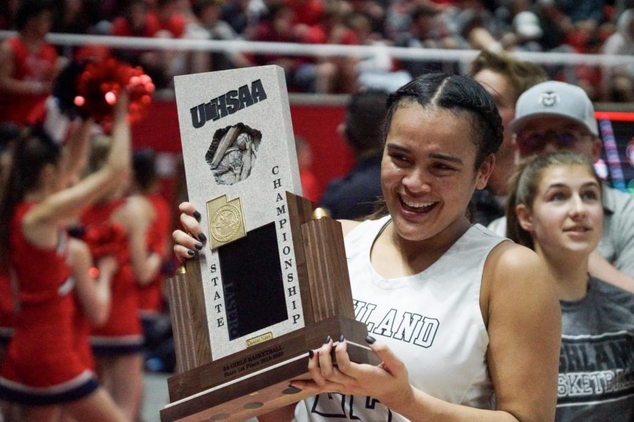 Kaija Glasker holds Highland's trophy high after winning the state championship.