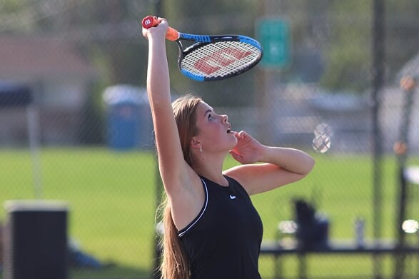 Emma Siepherd serving in a tennis match this season. The Varsity team took first place in region for the second year in a row.