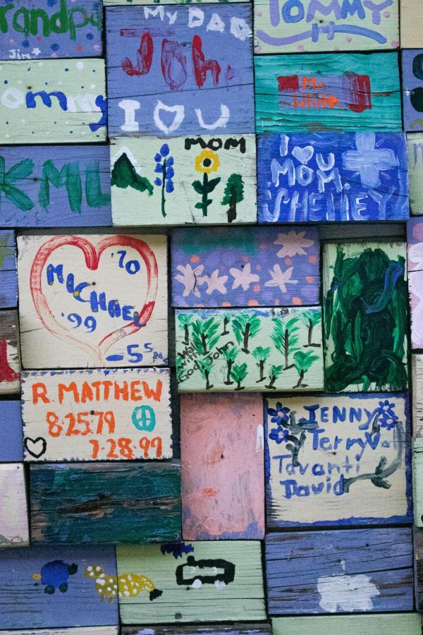 The memory wall outside of the Sharing Place honors families of members.