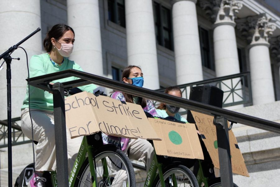 Students pedal bikes to power speakers at the Earth Day protest.