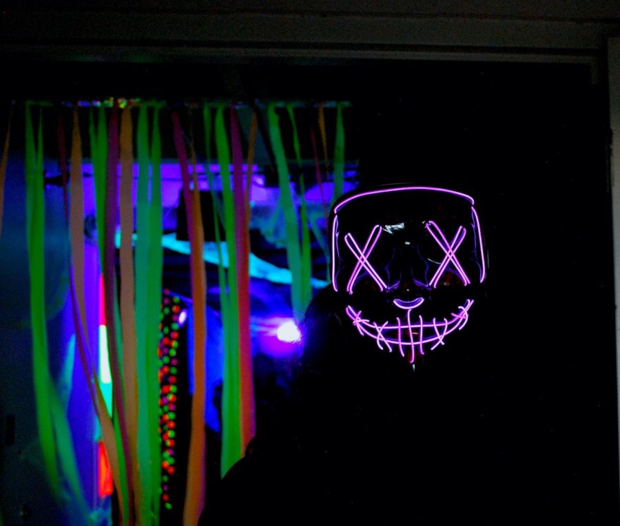 A+neon-masked+guide+meets+guests+at+Highland+spook+alley