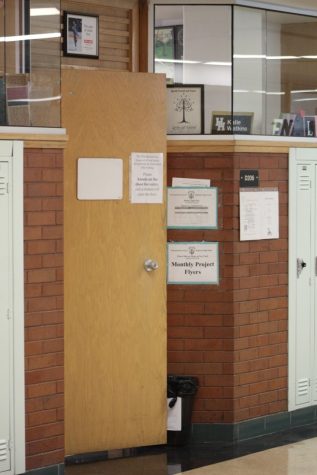 A trash can holds open Highland teacher Katie Watkins door. 