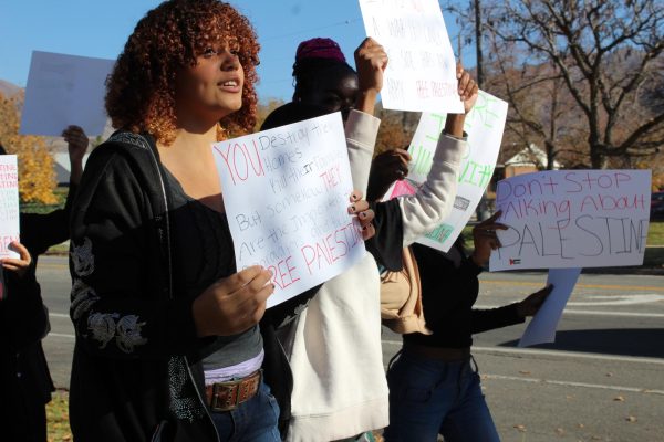 Students march along 17th East with signs expressing their sympathies.