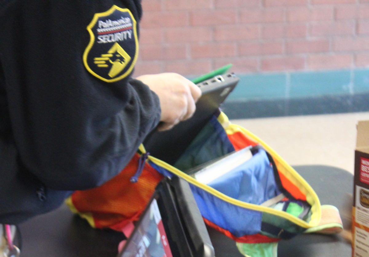 A Highland security agent inspects a students bag
