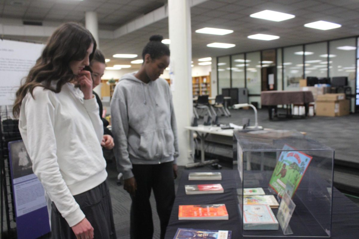 Highland students look on at a collection of books on Black history.