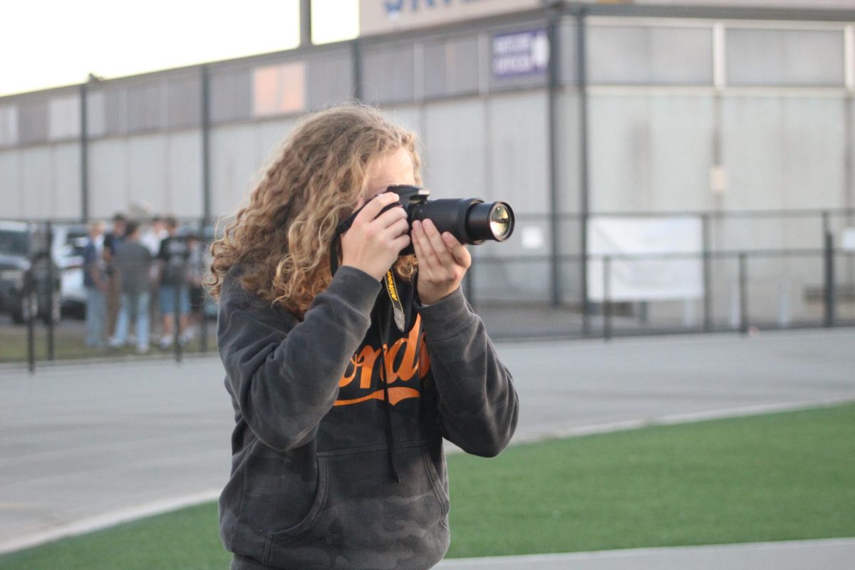 Lords with his camera at a football game. 