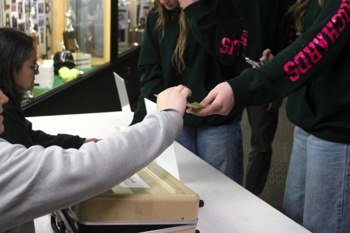 Students pay to enter the Sadies dance.