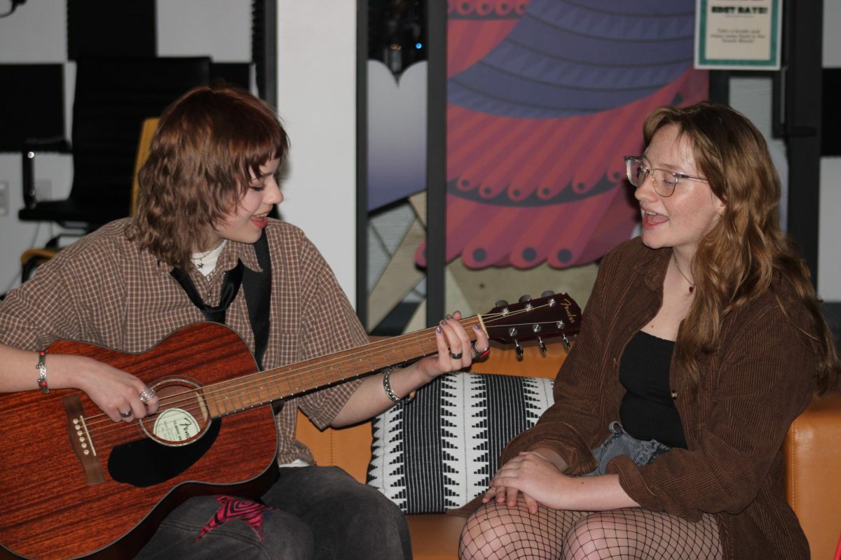 Louise Pederson (right) and Tinslay Smith (left) practice one of Nowhere Lane's newer songs.