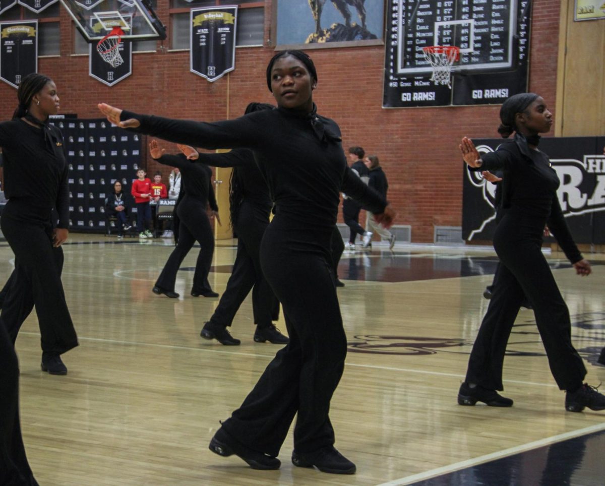 The Highland step team performing at a halftime show during a basketball game.