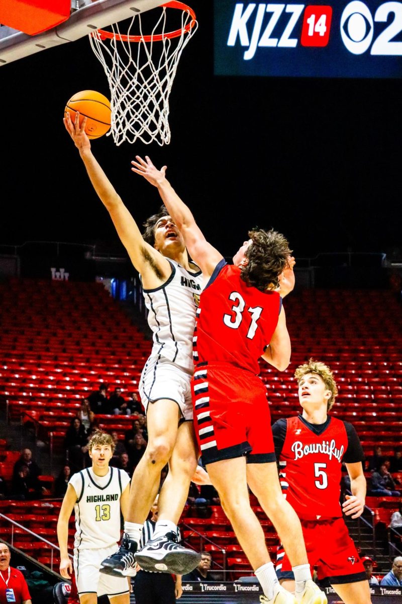 Senior Vai Higby taking a contested layup. 