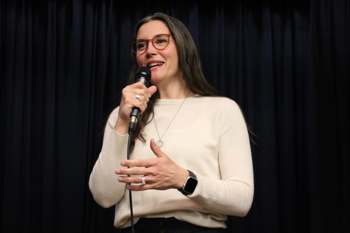 Mendenhall speaking to students in the Highland little theater. 