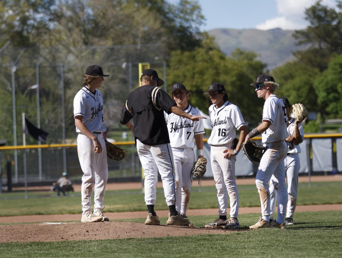 Coach Andrew Thomas takes a mound visit during a game
