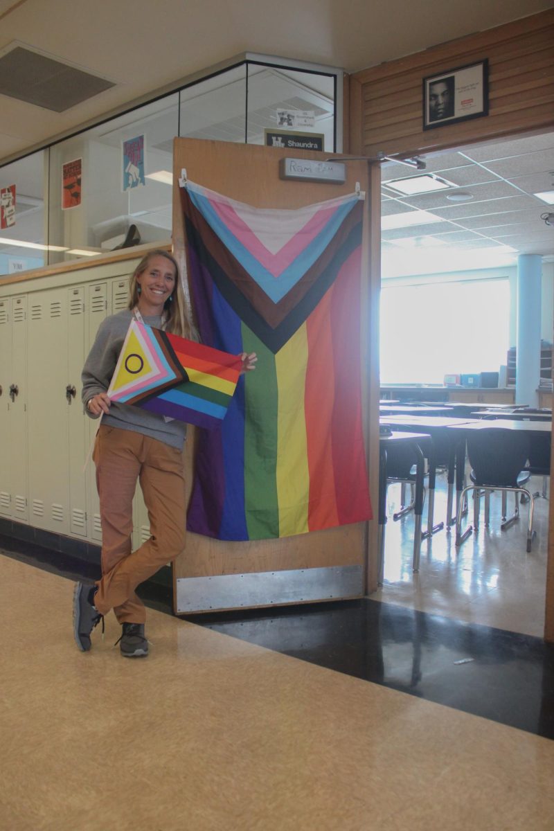 Jennifer Jacobson poses with her pride flags before she has to take them down.