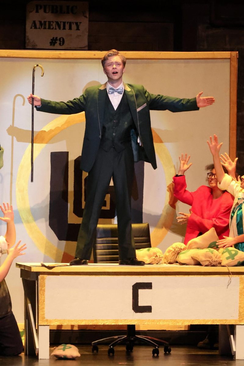 Thomas Lambert as Caldwell B. Cladwell in Urinetown.