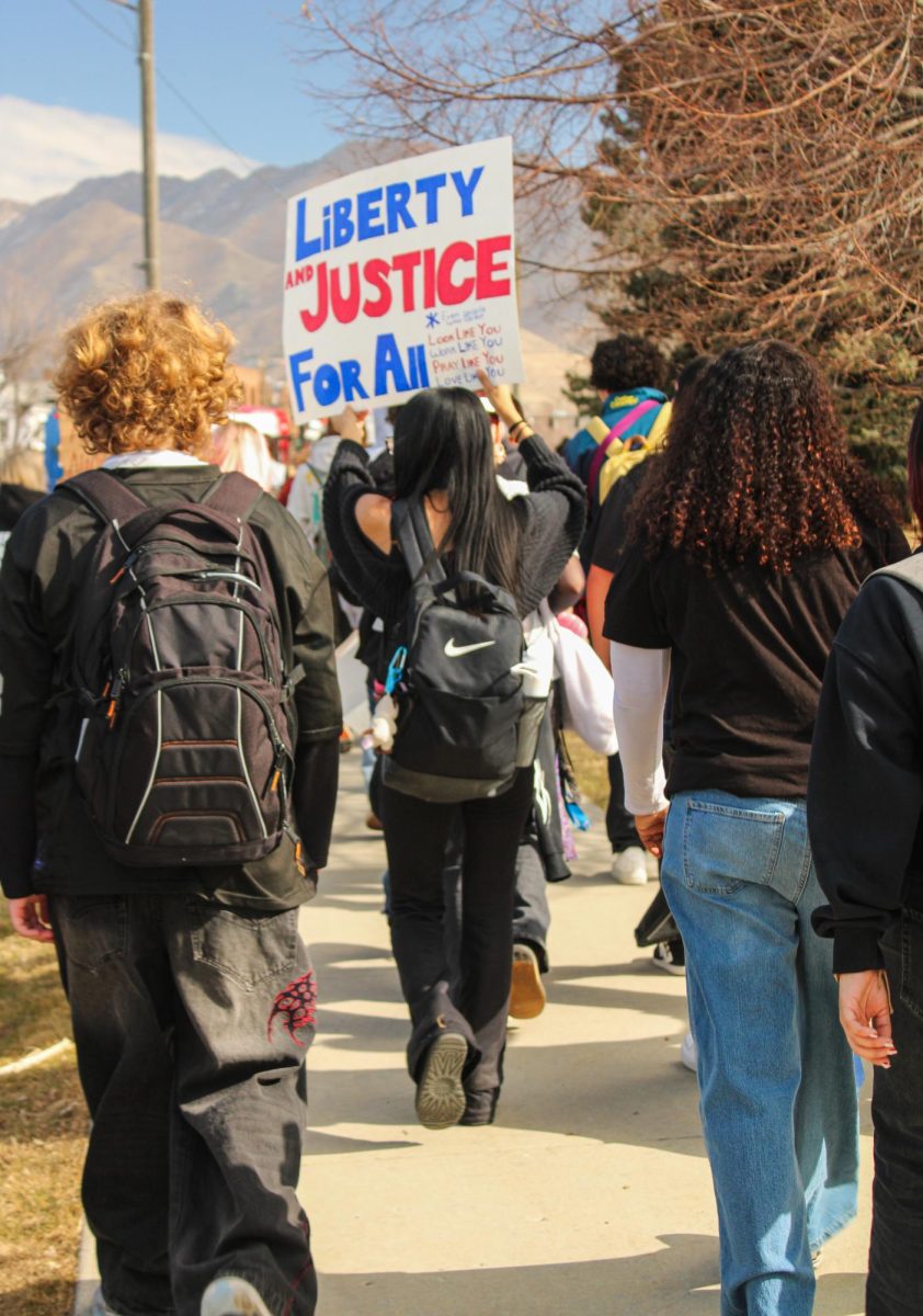 Highland student holds up sign at anti-ICE walkout on February 6. 